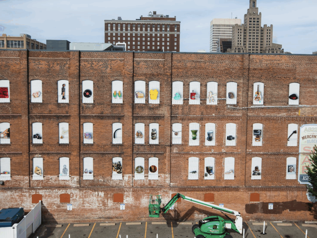 Image of a city scape depicting a facade full of objects. Joy, dialogue, inclusion, The Avenue Concept
